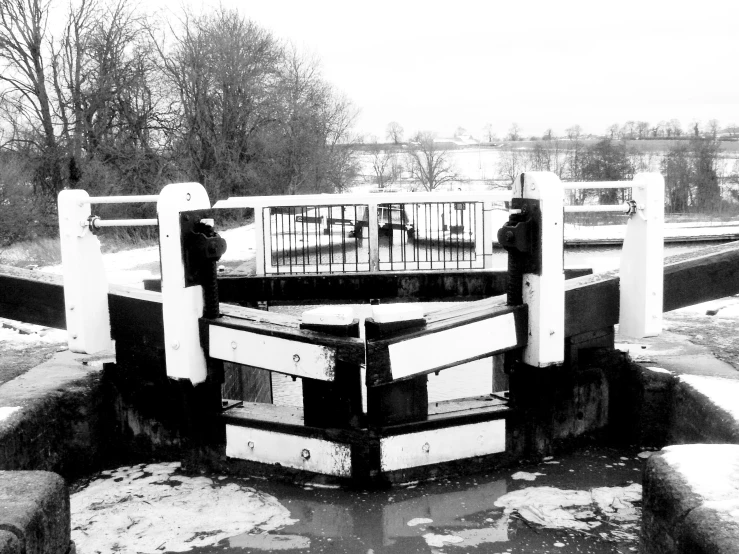 a black and white po of a pier near the water