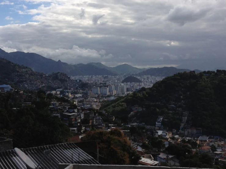 a city is seen from a nearby hill