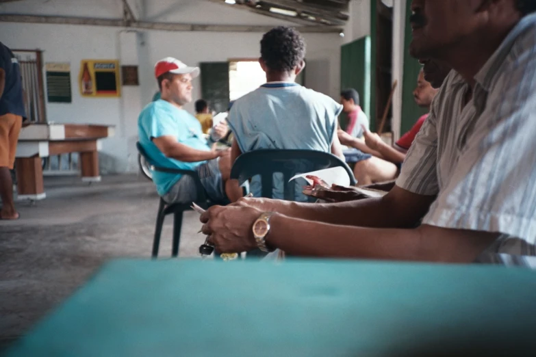 several men sitting at a table and eating