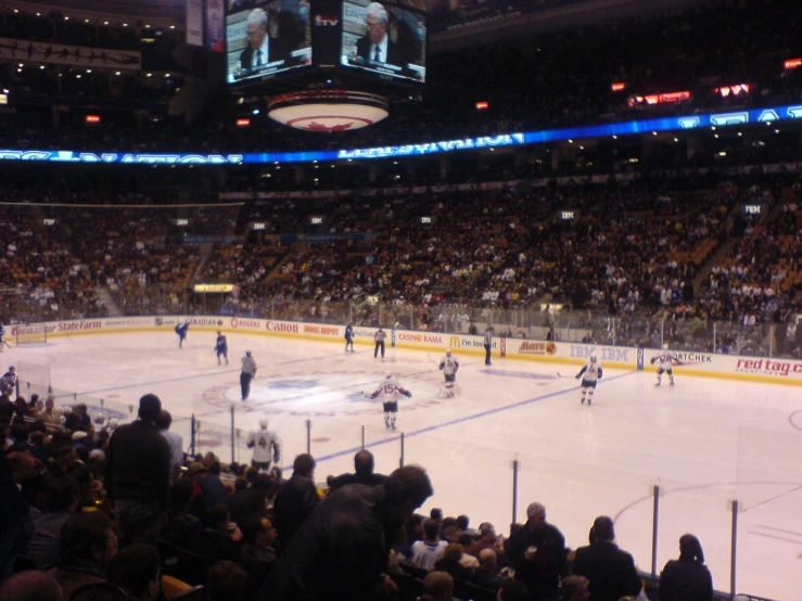 a hockey game in an arena with spectators