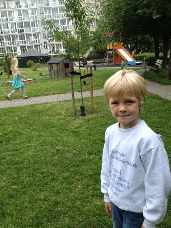 a young blond boy smiling for the camera