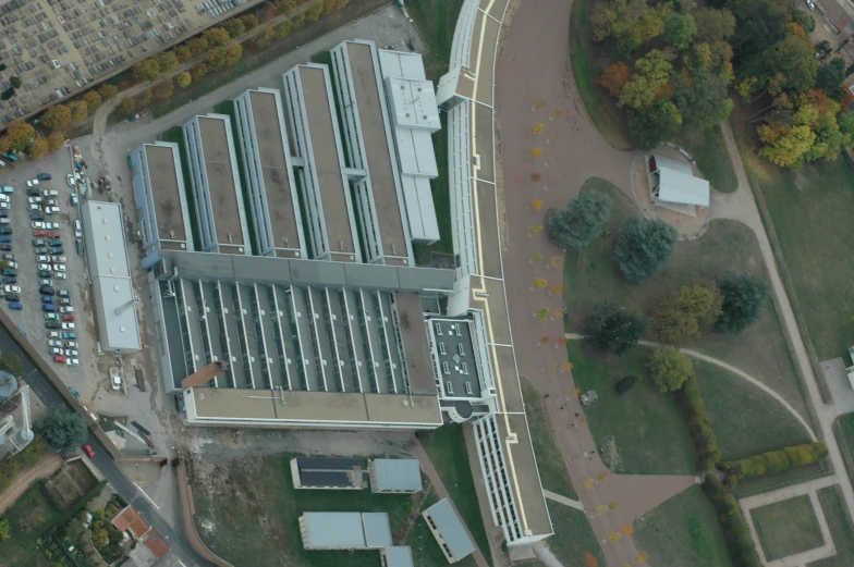 an aerial view of a building next to a freeway