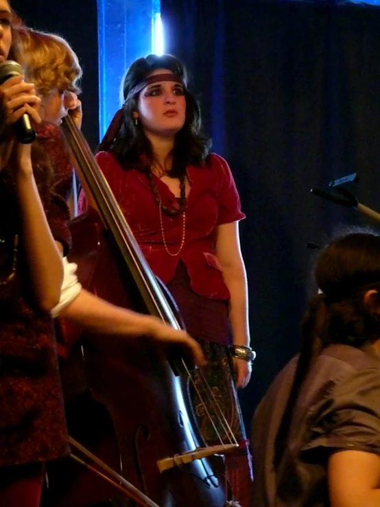 the woman in the red dress is singing into a microphone