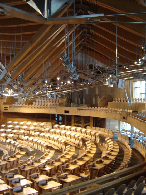 a large auditorium with chairs inside and a ceiling