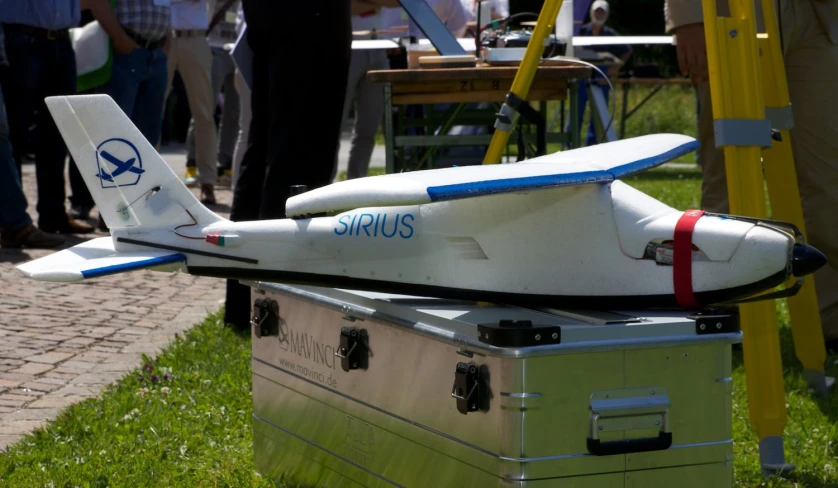 a toy airplane sits in a case at an outdoor event