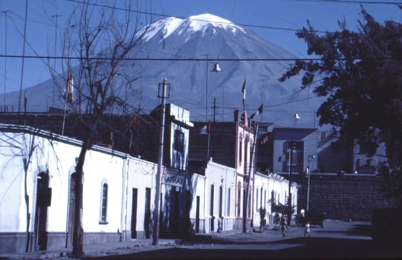 a city street in front of a snow covered mountain