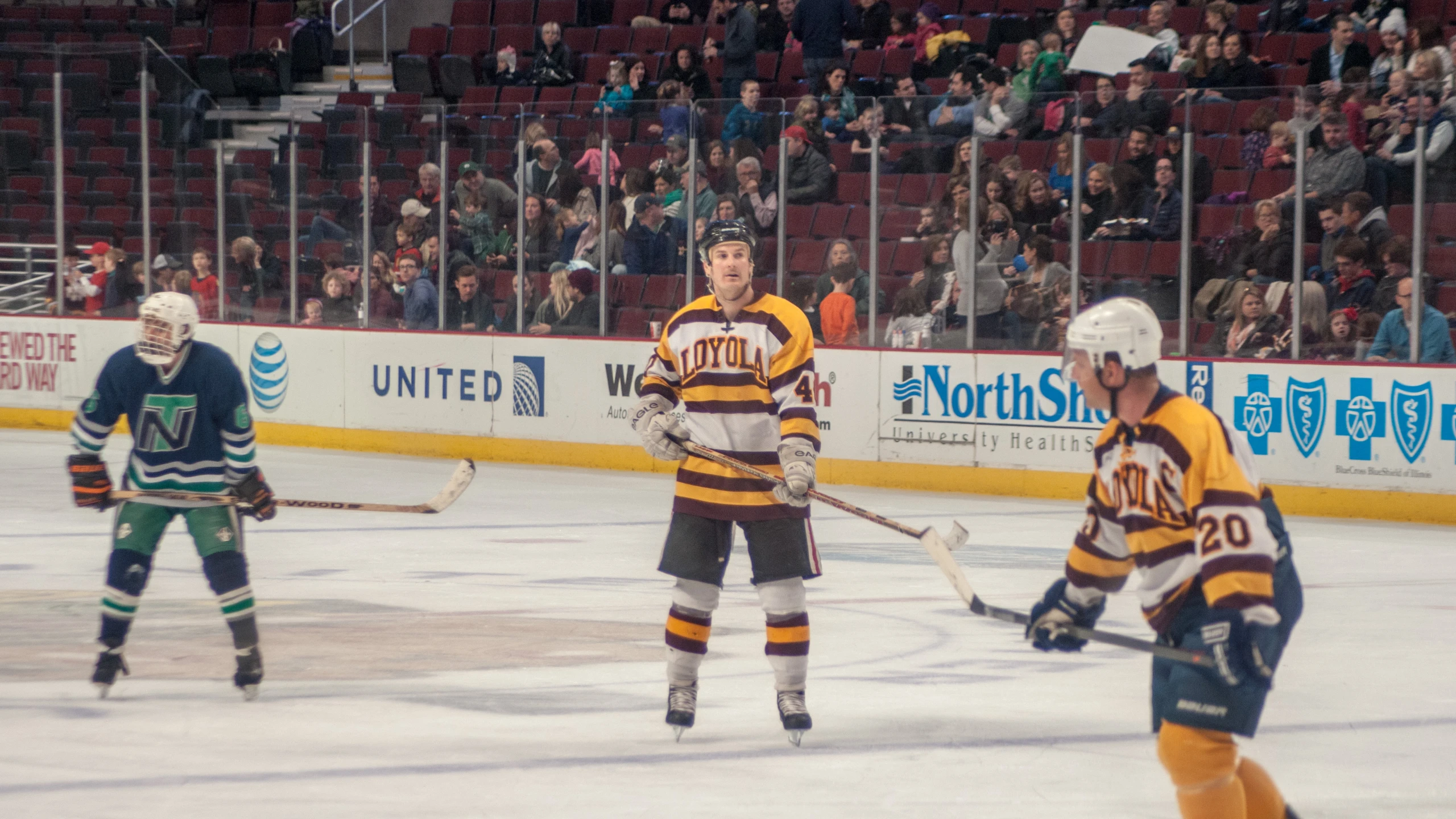 a group of people playing a game of ice hockey