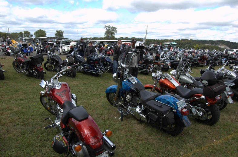 many motorcycles are lined up at an outside show