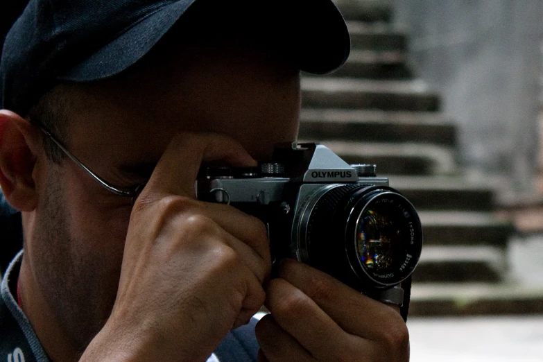 a man is holding a camera up to his face