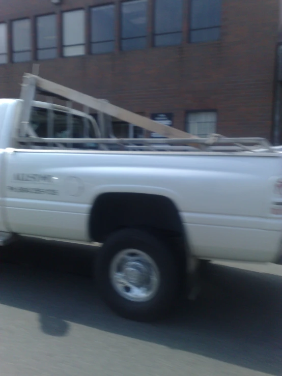 a white truck is towing a long box with an oversize bed