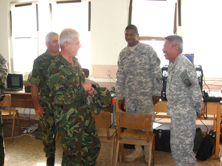 a couple of soldiers are shaking hands with each other