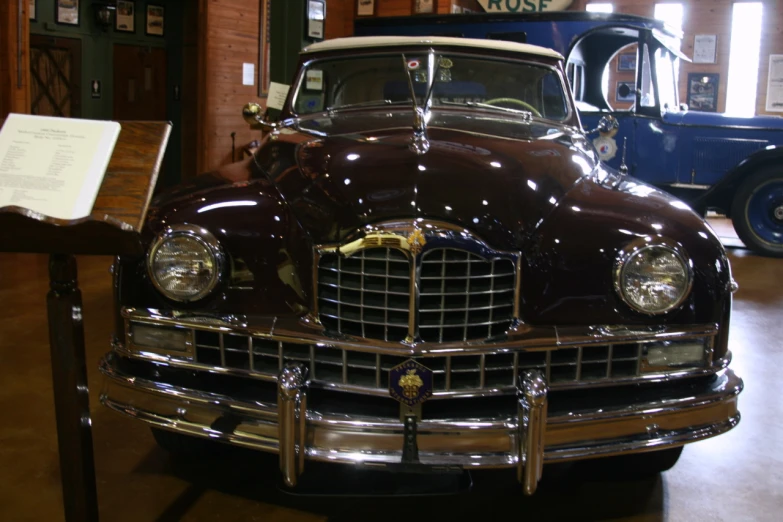 an antique car parked inside of a museum