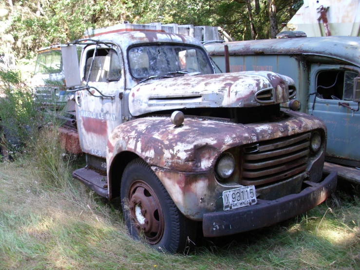 several old trucks are parked on the grass