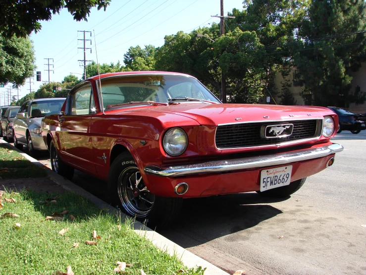 there is a red mustang parked on the street