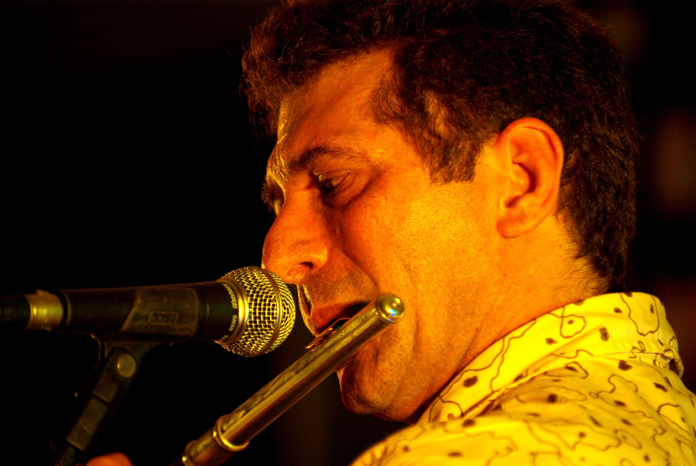 a man singing into a microphone with a big mouth