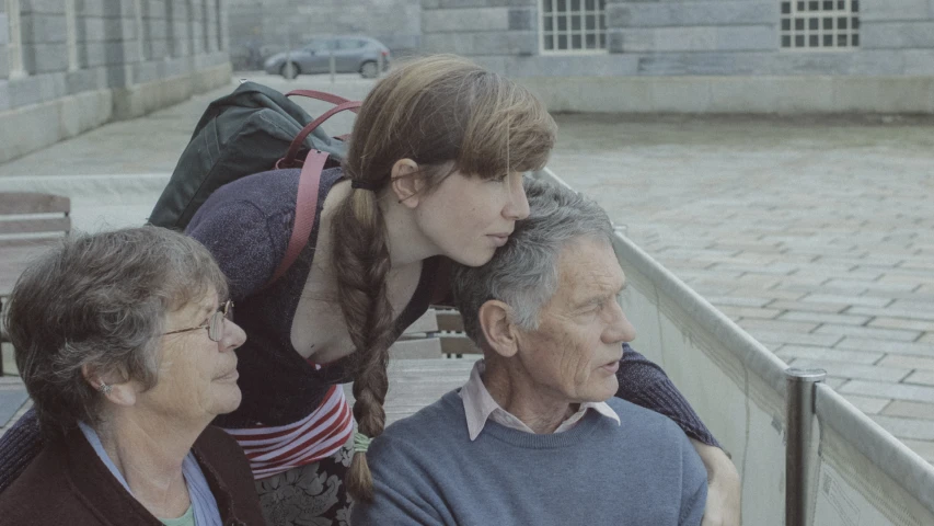 two elderly people sitting on a bench next to each other