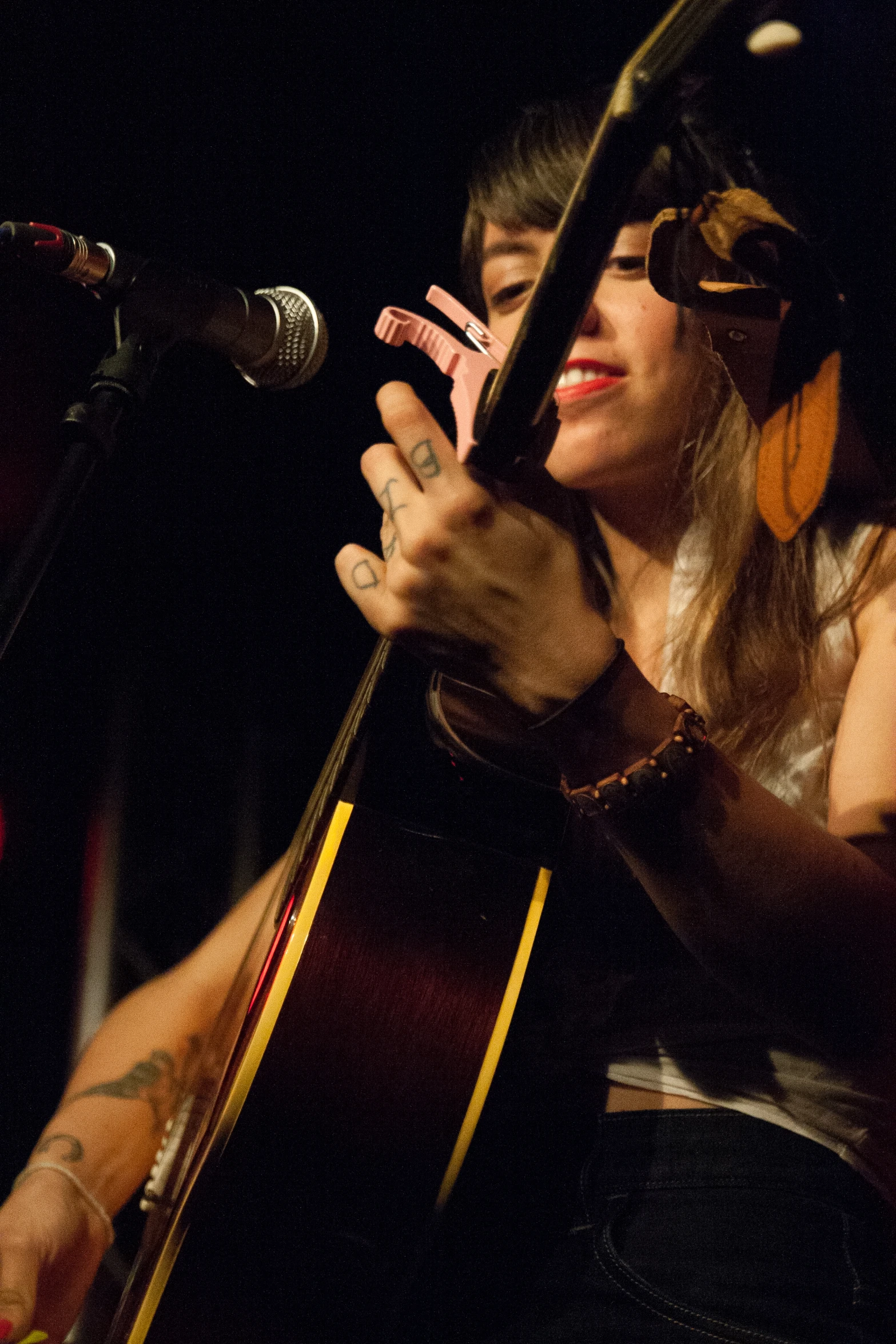 a woman that is holding a guitar on stage