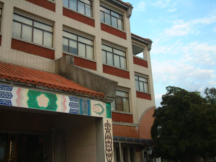 a building with colorful wall paint in front of a red and white tiled roof