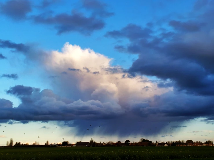 a large cloud is towering into the sky