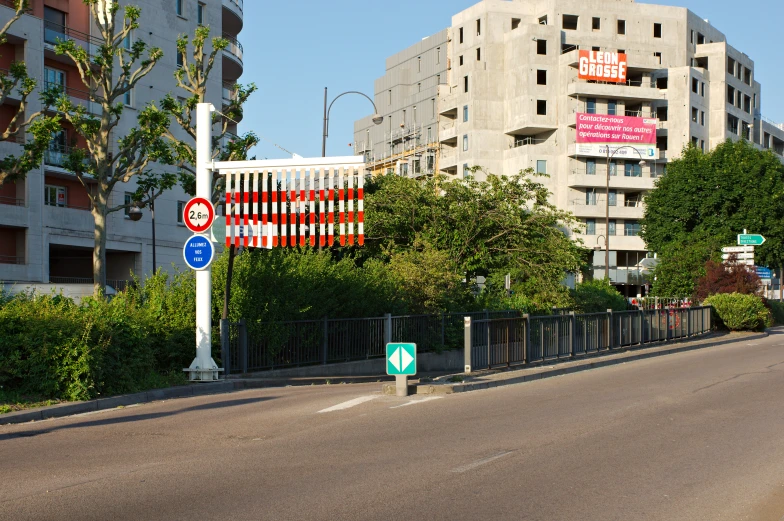 a large street with street signs near some buildings