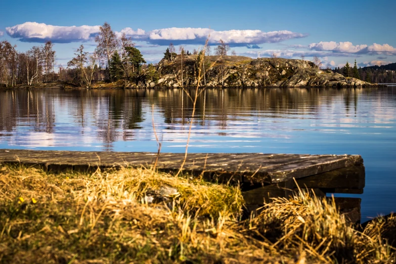 the view of a beautiful lake with water on either side and land around it