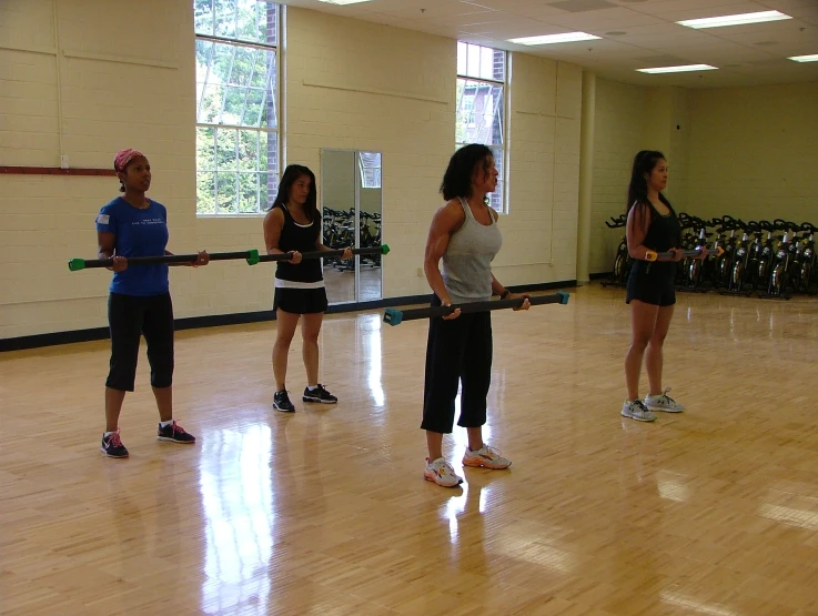 a group of women practicing exercises on the dance floor