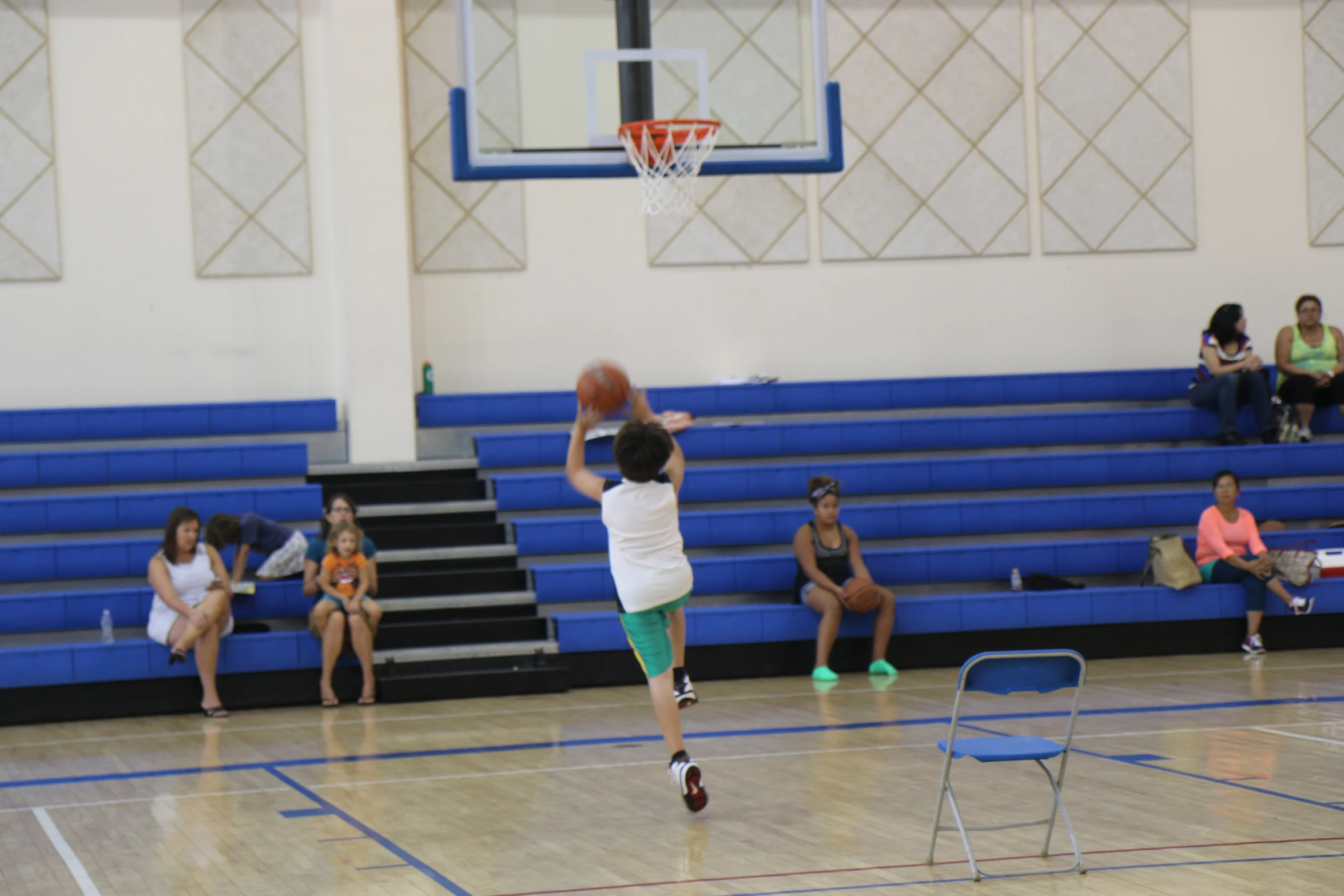 a person with a basketball in a gym