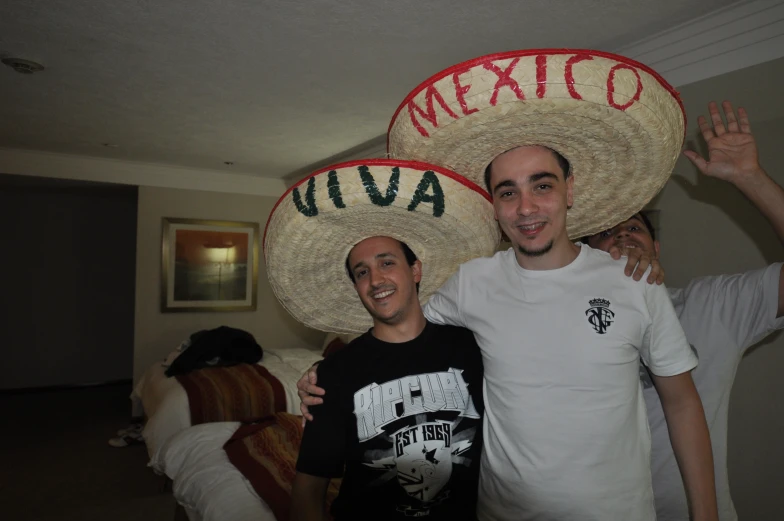 two men standing next to each other in front of a sign