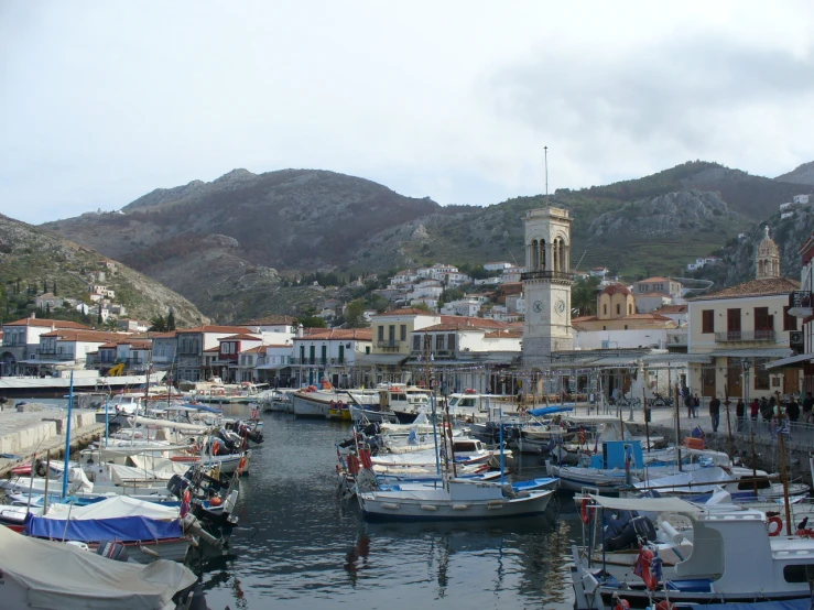 a marina filled with boats in front of buildings