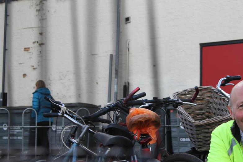 a man smiles in front of some bikes