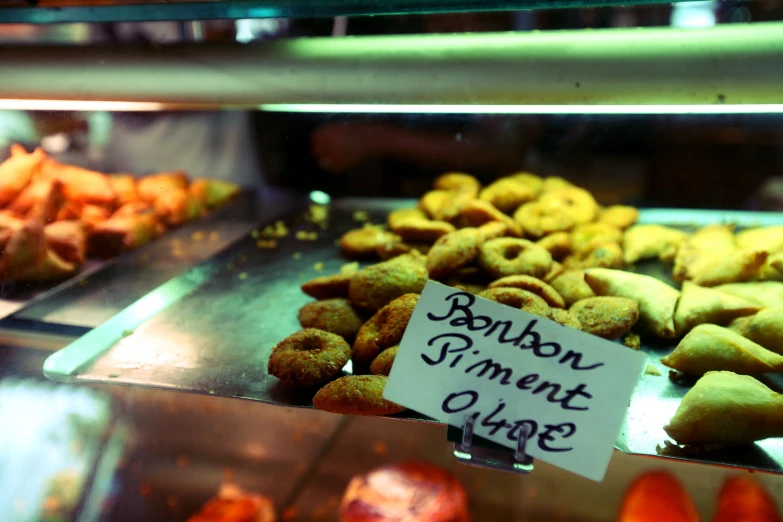 there are some baked items behind a glass