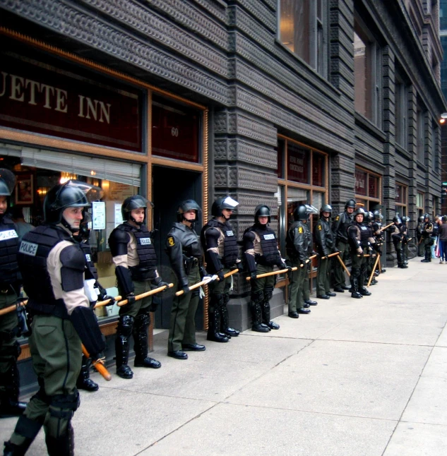 the line of police officers have been kept close together outside