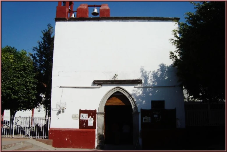 this is a building with a red door and windows