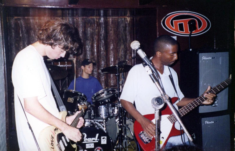 a group of young people playing instruments in a music room