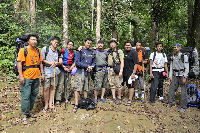 people pose for a po in front of the woods