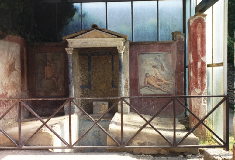 a small sculpture in an old building near two paintings