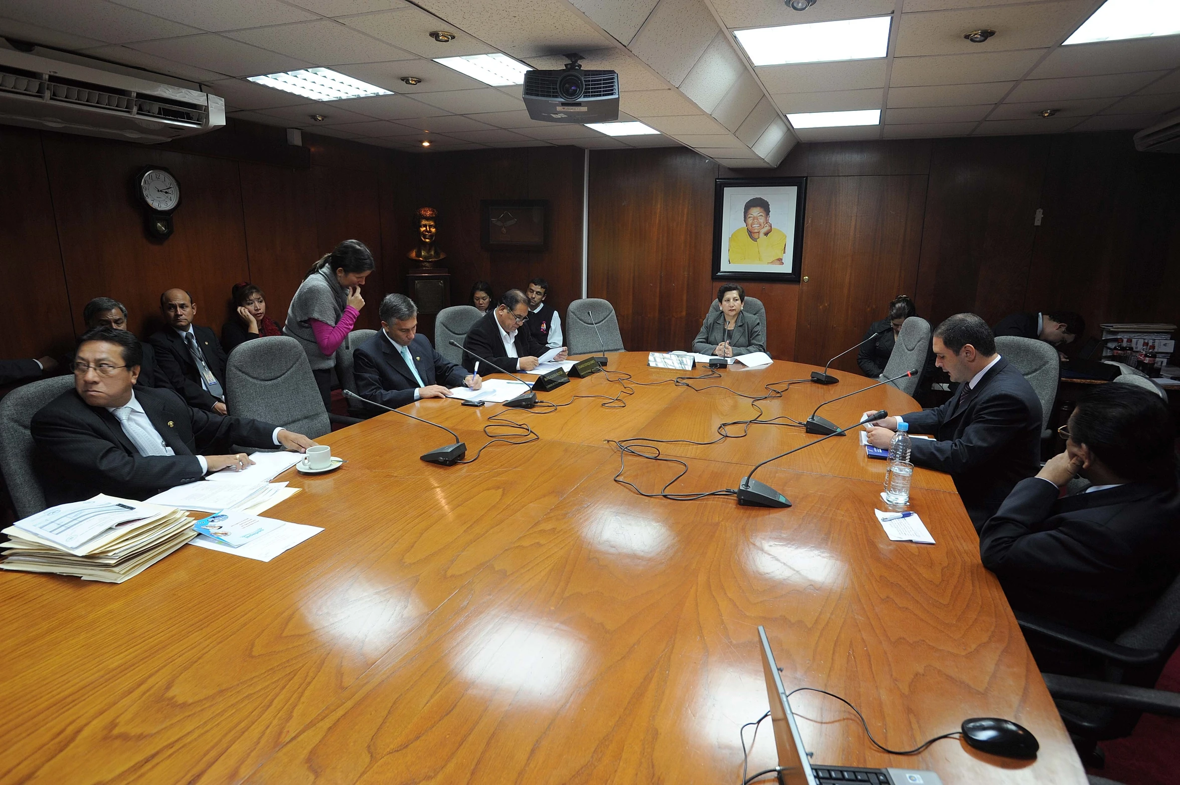 a meeting room with a table full of people