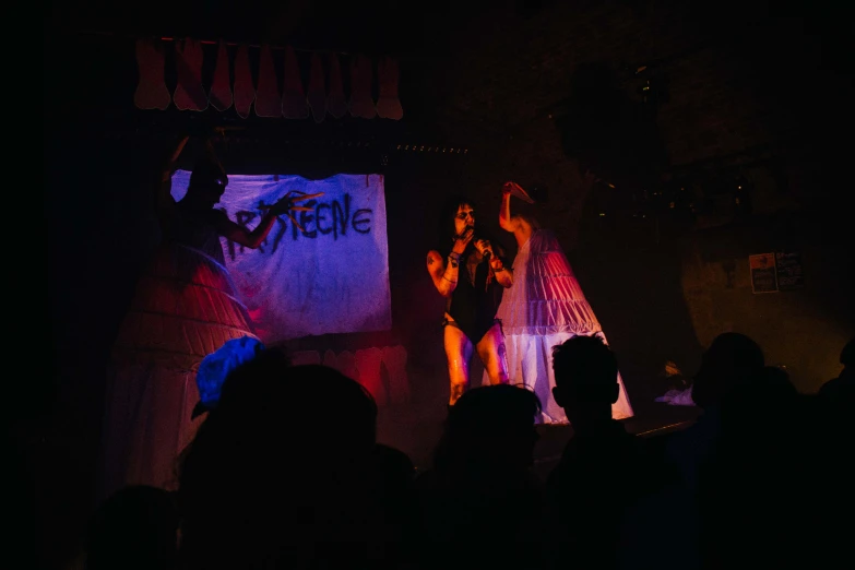 a couple of women on a stage in front of a crowd