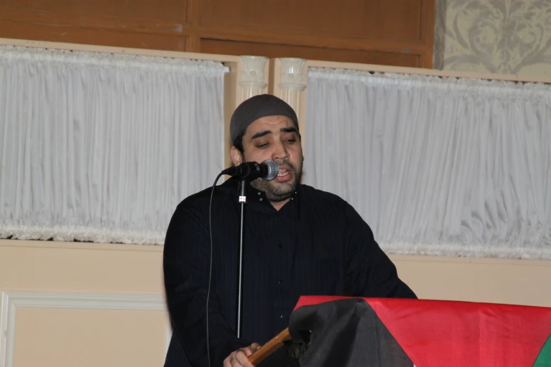 a man holding a microphone at an event
