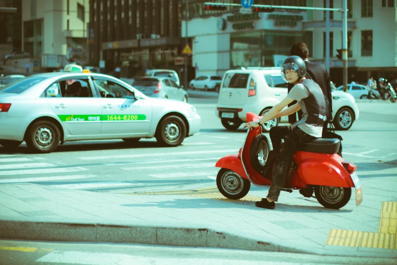 a man is riding a scooter on the street