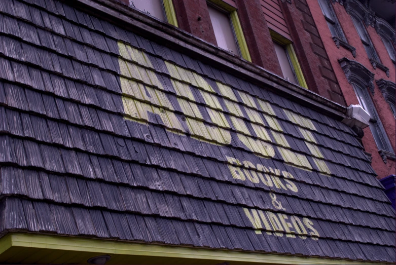 the neon sign is on the brown brick building