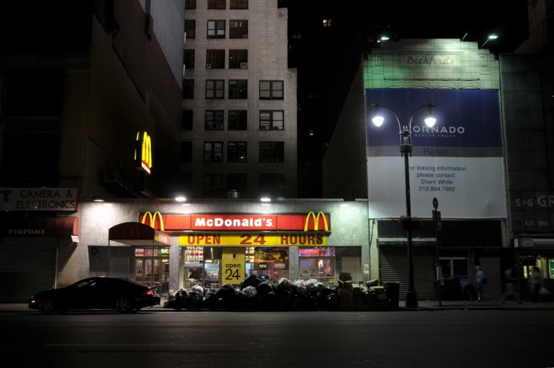 a mcdonald's restaurant is lit up at night