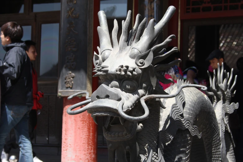 a dragon statue outside in a chinese city