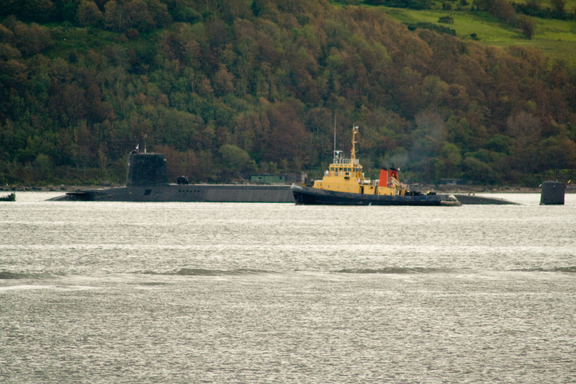 a large tugboat travels along the water