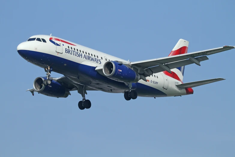 a jumbo jet airplane flying in a blue sky