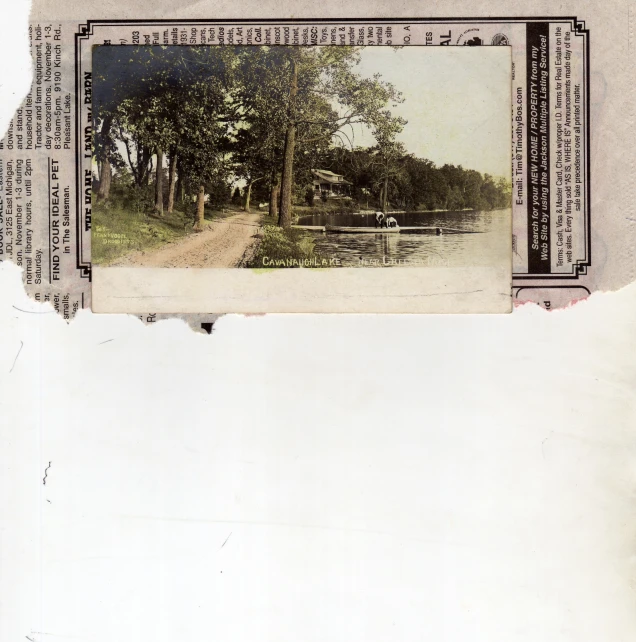 an old po showing the back side of a paper with a pograph of trees and a road