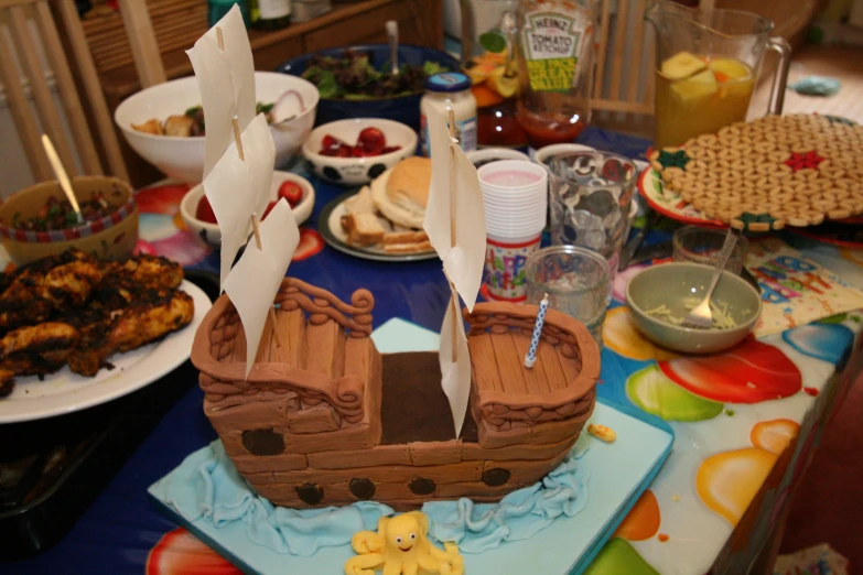 a table filled with food with a pirate ship design on it