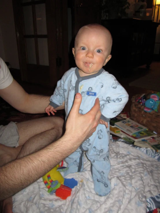 a small baby is sitting in front of a person