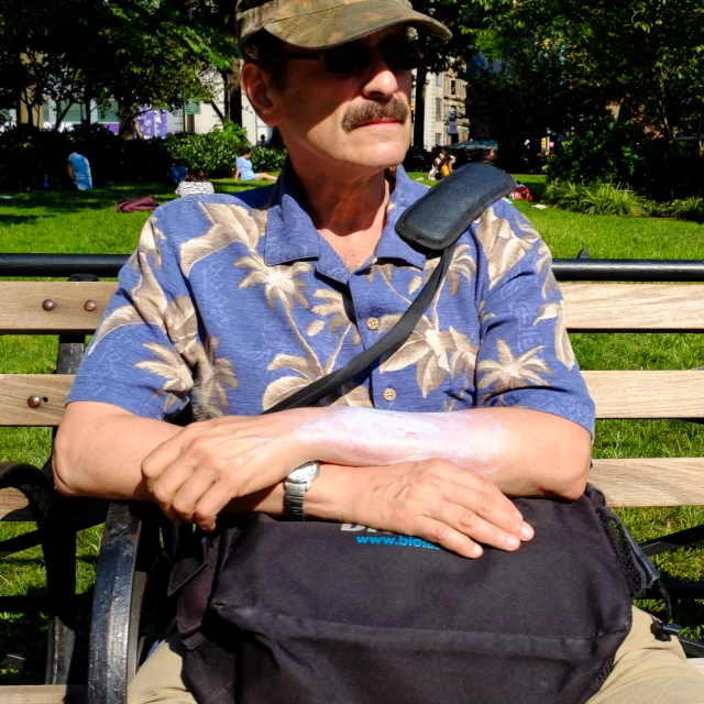 a man in a baseball hat sitting on a bench