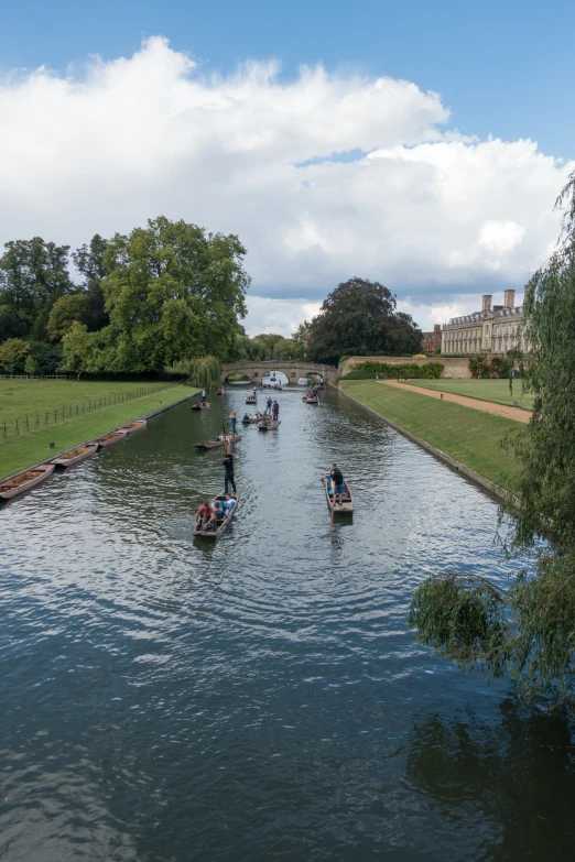 people in boats are going down a river